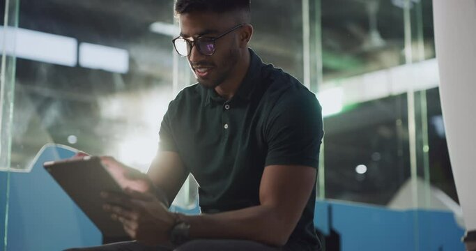 Tablet, happy and businessman working online or on the internet on a project in a tech startup company. Worker, technology and man employee typing a proposal or strategy at the workplace or office