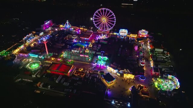 Drone shot of Amusement Park at night in the Zentrale Festplatz Berlin ( Central fairground Berlin ) , it is a site for holding outdoor events . 