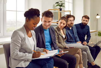 Diverse millennials and young people attend business seminar or training together. Happy...