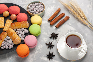 top view cakes and bagels with candies crackers and cup of tea on light white background cake biscuit cookie sugar sweet pie