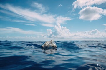 Fototapeta premium plastic bag floating in the middle of the ocean, with view of blue sky and clouds, created with generative ai