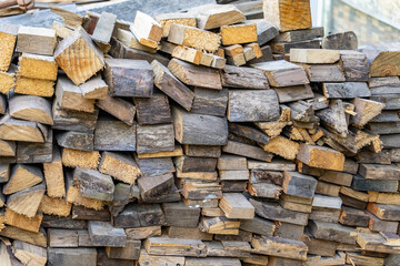 Wooden boards are stacked in a sawmill or carpentry shop