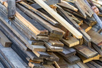 Wooden boards are stacked in a sawmill or carpentry shop