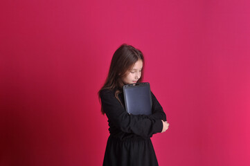estudante segurando quadro em fundo rosa 