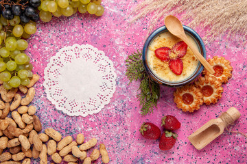 top view delicious creamy dessert with fresh green grapes cookies and peanuts on light-pink background dessert ice-cream berry cream sweet fruit