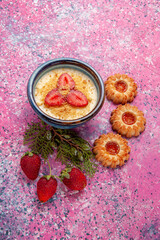 top view delicious creamy dessert with red sliced strawberries and cookies on light pink background dessert ice-cream cream color sweet ice