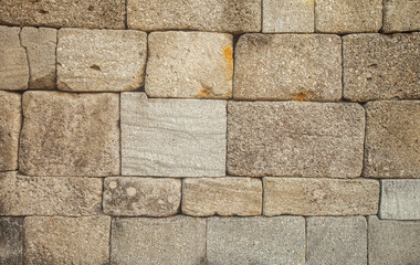 Ancient stone wall background and texture. These stone blocks were used to build temples in the Java region of Indonesia.