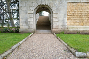 Fototapeta na wymiar Tunnel side entrance located at a former stately home in the UK. Steps can be seen, which leads to a separate garden area.
