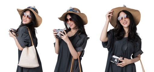 Young Asian woman Wearing a dress with a sun hat and sunglasses holding a camera travel concept...