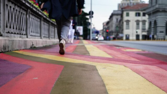 Street sidewalk with multi colored changing rainbow flag