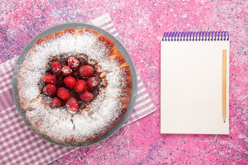 top view delicious strawberry cake sugar powdered with notepad on pink background cake sweet sugar cookie tea
