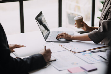 Businesswoman or accountant working Financial investment on calculator, calculate, analyze business and marketing growth on financial document data graph, Accounting, Economic, commercial concept.