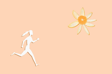 Silhouette of a person running towards the sun. Beige background. Concept
