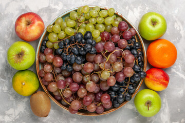 top view different grapes with other fresh fruits on the light white desk fruits fresh mellow juice summer