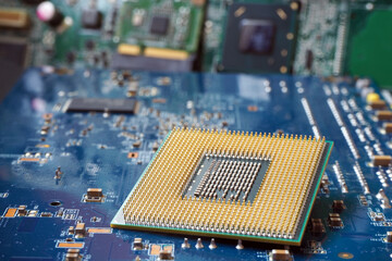 A microprocessor laid in front of the motherboard. Semiconductor and computer industry concept.