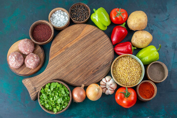 top view fresh vegetables with different seasonings and greens on dark blue desk vegetables food meal dish greens