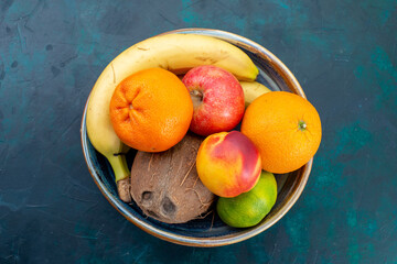top view fruit composition tangerines bananas apples and coconut on dark-blue desk fruit fresh vitamine exotic tropical - obrazy, fototapety, plakaty