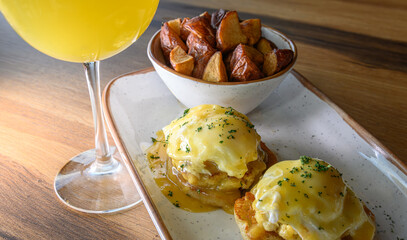 Eggs Benedict with Home Fries and a Mimosa