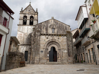 Fototapeta na wymiar Church of San Juan de Ribadavia, 12th century, in Orense, Spain, summer of 2021, with a green door with semicircular archivolts and a military appearance.