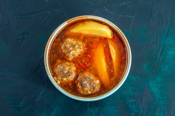 top view meat balls soup with potatoes inside round plate on the dark blue background food soup meat dish dinner vegetable