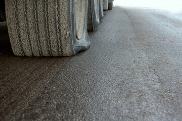 View of a punctured truck wheel. A flat tire of a car on a road waiting to be repaired.