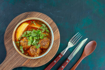 top view meat soup with meatballs greens and sliced potatoes on dark blue desk food soup sauce vegetables dish
