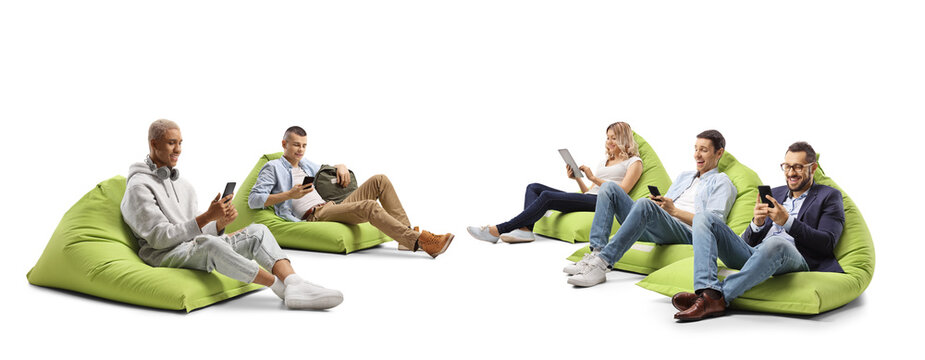 Young people sitting on a bean bag armchairs and using smartphones