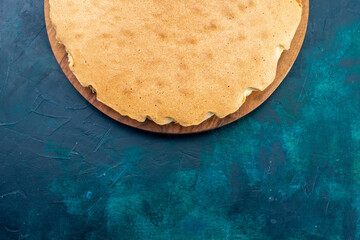 top view plain cake dough baked round formed on dark-blue desk cake bake sweet sugar dough pie - obrazy, fototapety, plakaty