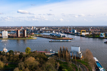 Naklejka premium Rotterdam Netherlands port and cityscape. Panoramic view from Euromast tower, sunny day, cloudy blue sky 