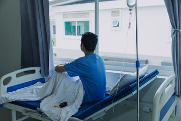 Fototapeta premium Terminally Ill Male Patient Lies on a Bad In the Hospital. Melancholy and Exhausted Patient in the Palliative Care Ward.