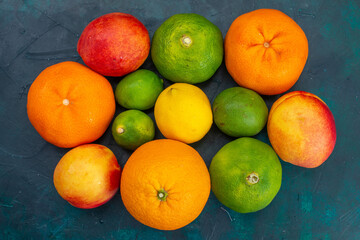 top view tangerines and peaches fresh mellow fruits on dark-blue desk fruit vitamine exotic citrus