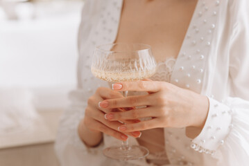 Fototapeta na wymiar bride holding a glass of champagne