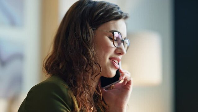 Closeup woman talking phone with smile indoors. Cheerful girl speaking telephone