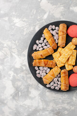 top view yummy cakes with bagels and candies on the white background cake biscuit cookies sugar sweet pie