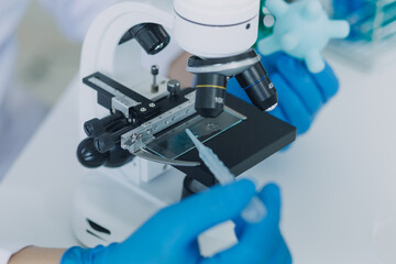 microscope with lab glassware, science laboratory research and development concept