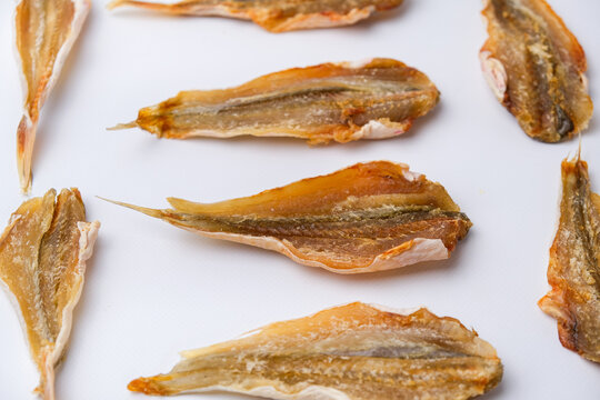 Dried salted fish for beer on a white background. Close-up.