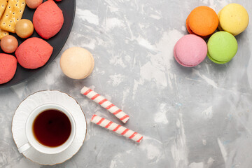 top view yummy cakes with crackers macarons and cup of tea on the grey-white desk cake biscuit cookies sugar sweet pie