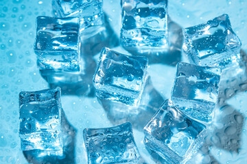 Wet ice cubes on a blue background.