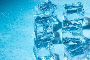 Wet ice cubes on a blue background.