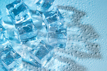 Wet ice cubes on a blue background.