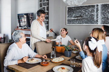 latin family of multi generational women eating together at home in Mexico Latin America, hispanic...