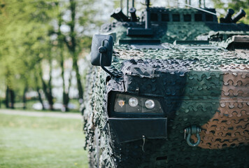 camouflaged wolverine-type military combat vehicle