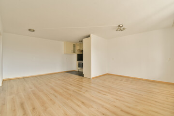 an empty living room with wood flooring and white walls in the room is very clean, ready to use