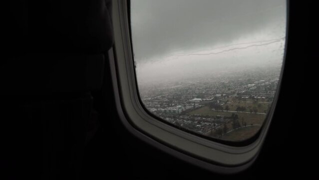 Preparing for a private flight. Airplane taking off from the airport. Rainy Day. Modern private business jet leather seats and interior. 