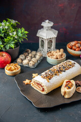 front view delicious biscuit roll with nuts on dark background pie cookie cake dessert tea sugar dough fruit flower