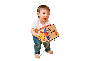 Toddler baby is playing logic educational games busyboard on a studio isolated on a white background. Happy child play with educational toy, learning logic. Kid aged one year and four months