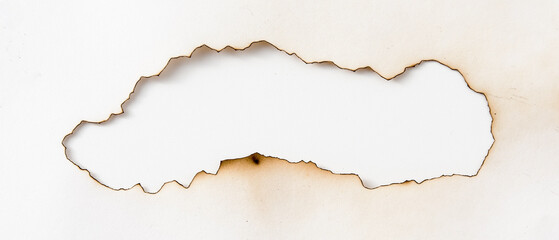 burnt holes in a piece of paper isolated on white background