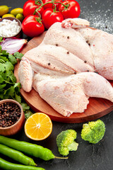 front view fresh raw chicken with greens and red tomatoes on dark background pepper health cooking dish salad food dinner barbecue color