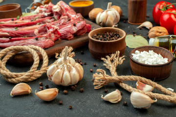 front view raw meat slice with fresh vegetables and seasonings on dark background salad butcher cooking meat dish meal