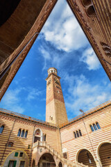 Fototapeta na wymiar Piazza delle Erbe (Market's Square) is a square in Verona, Italy. Lamberti Tower. Travel destination in Italy concept.